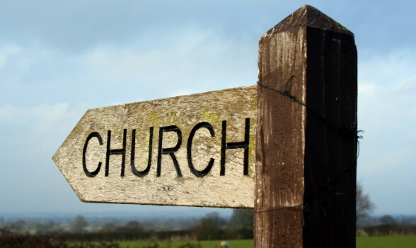 a wooden sign with church word on it